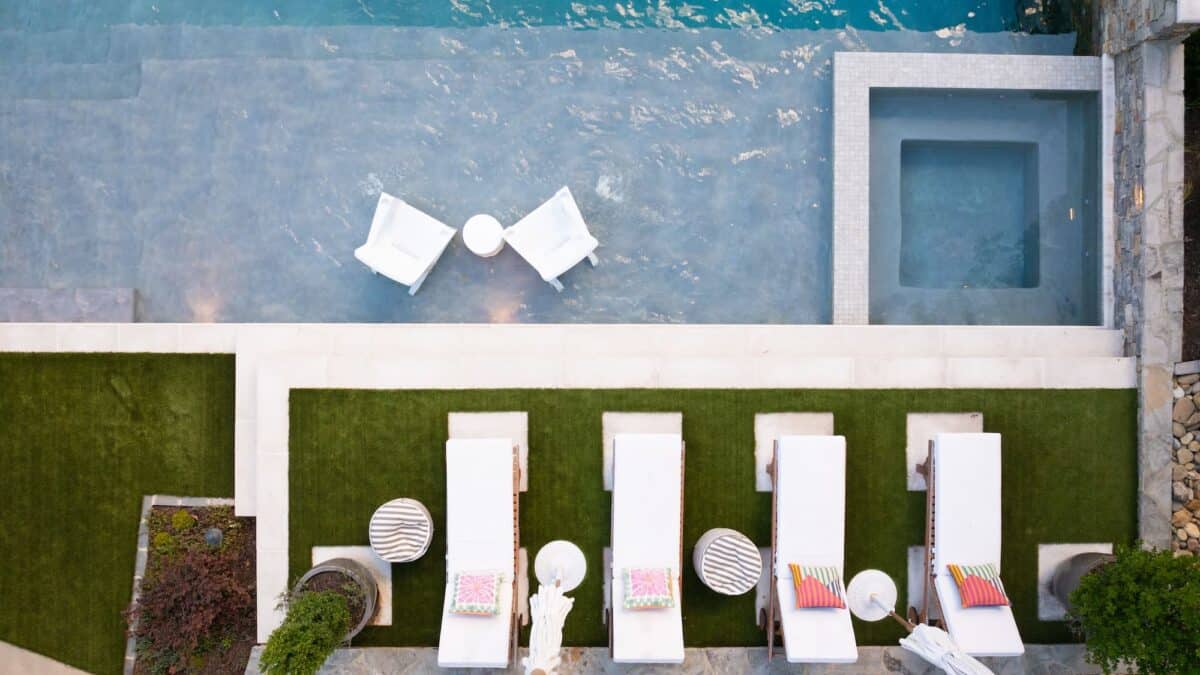 "Essential pool cleaning tools including a leaf skimmer net, brush, and thermometer for residential pool maintenance."