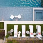 "Essential pool cleaning tools including a leaf skimmer net, brush, and thermometer for residential pool maintenance."