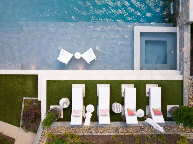 "Essential pool cleaning tools including a leaf skimmer net, brush, and thermometer for residential pool maintenance."